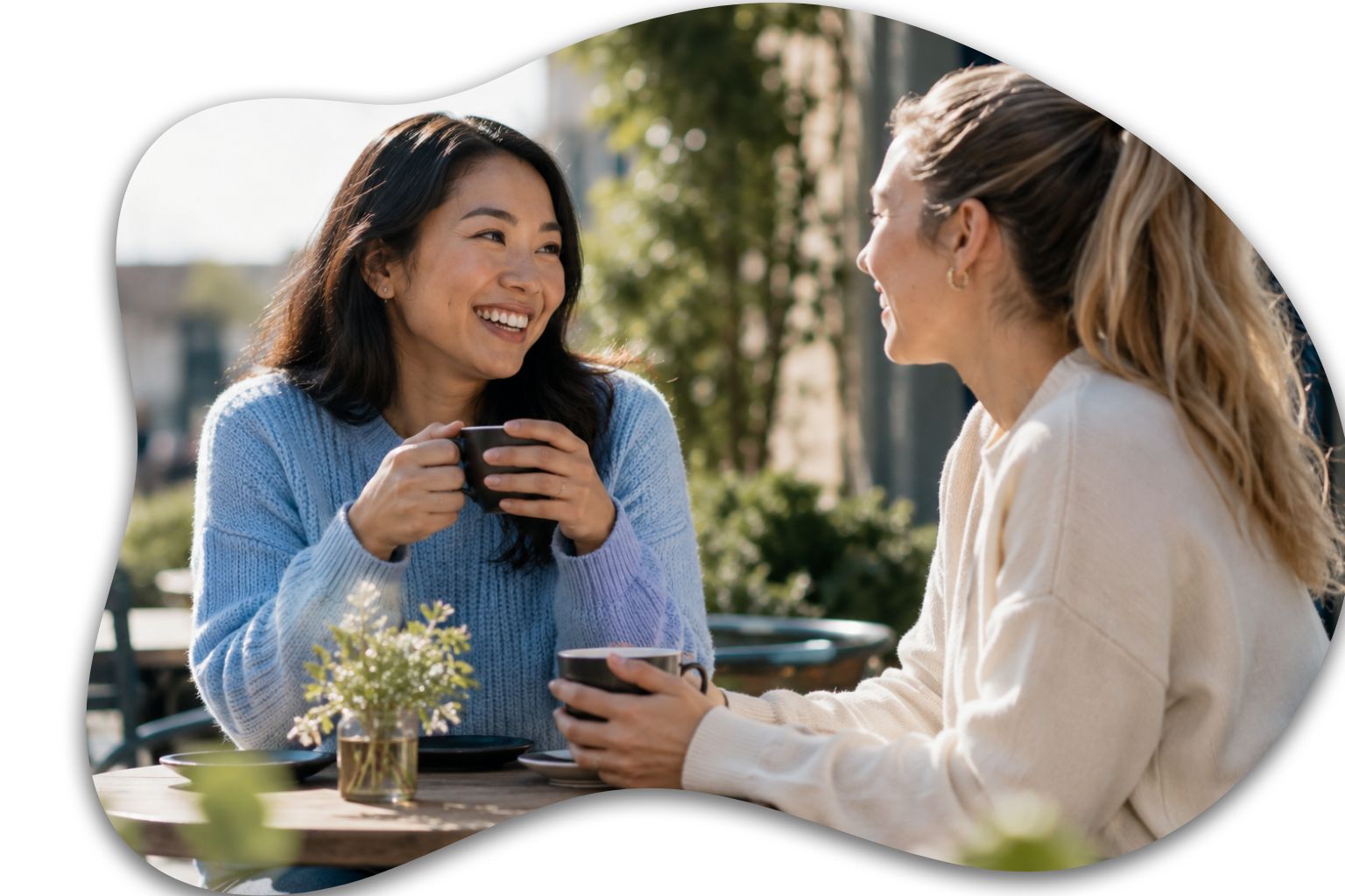 Image: Two friends enjoying a relaxed conversation outdoors